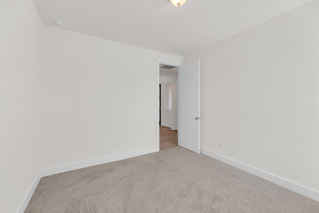 Carpeted spare room with visible vents and baseboards | Image 26