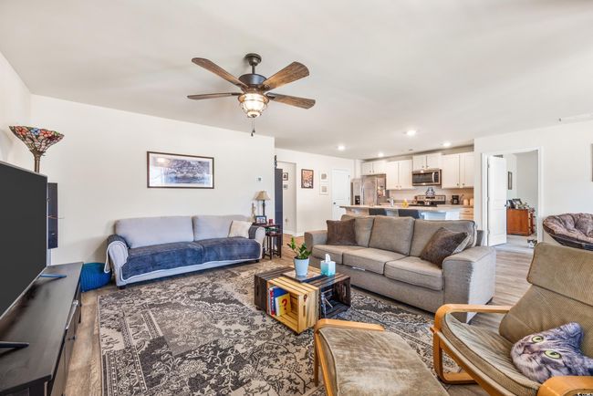 Living room featuring light wood-style floors, a chandelier, recessed lighting, and baseboards | Image 24