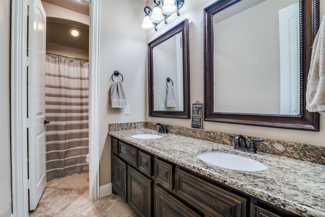 Full bath is uniquely designed with a privacy toilet and bathing area. The double sink vanity provides ample drawers and cabinet space for storage. It is designed with separate designer mirrors, stylish lighting and oil-rubbed bronze fixtures. | Image 25