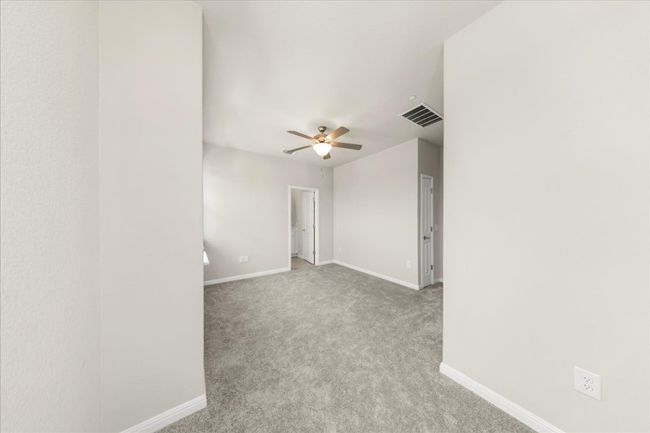 Empty room with carpet floors, baseboards, and a ceiling fan | Image 17