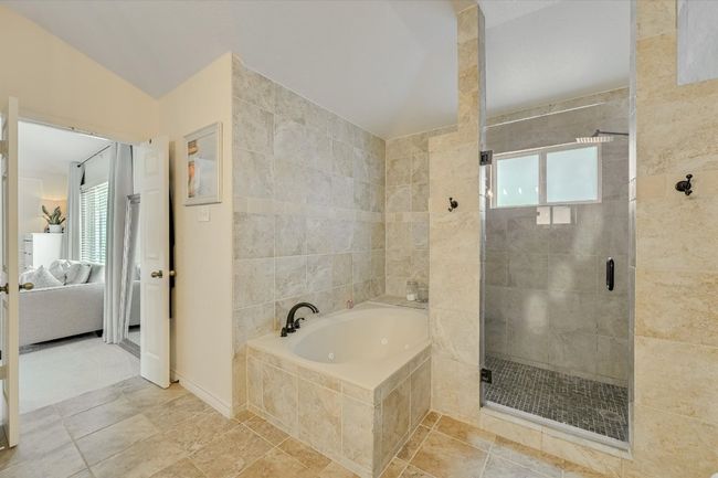 Bathroom featuring connected bathroom, a garden tub, healthy amount of natural light, and a shower stall | Image 21