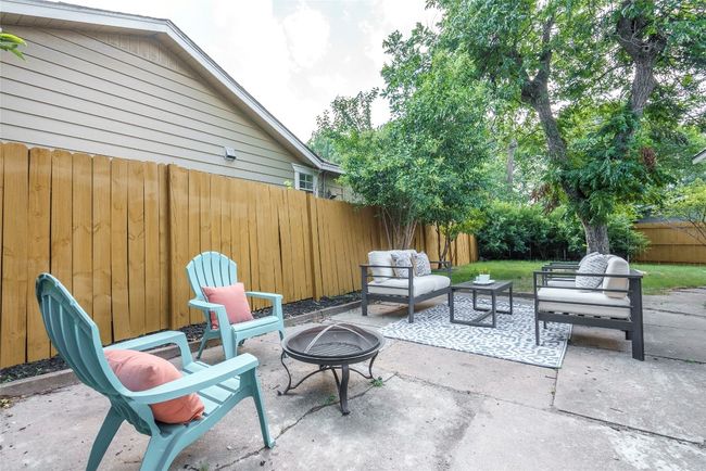 Fenced backyard featuring a patio area and an outdoor living space with a fire pit | Image 27