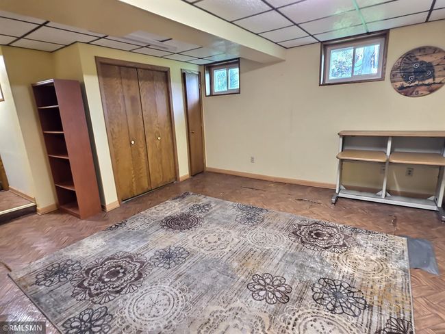 Head down through the Dutch door to the lower level to find a roomy space that can be used for many things. Extra storage options with the closets as well make this area appealing. | Image 15