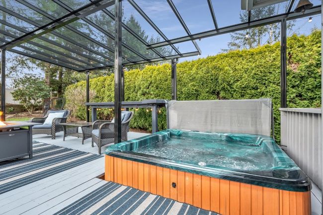 Wooden deck with a hot tub | Image 32