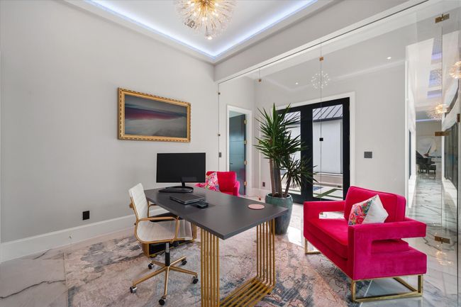 Home office featuring an inviting chandelier, marble finish floor, and baseboards | Image 13