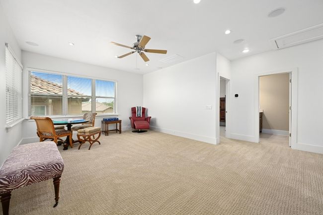 Living area featuring a ceiling fan, light colored carpet, baseboards, and recessed lighting | Image 17