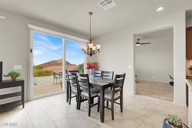 Dining space featuring a chandelier, recessed lighting, light carpet, light tile patterned flooring, and ceiling fan | Image 24