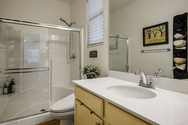 Bathroom #2 downstairs featuring toilet, a shower stall, and vanity | Image 25