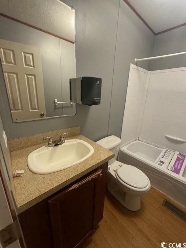 Bathroom with a sink and wood finished floors | Image 14