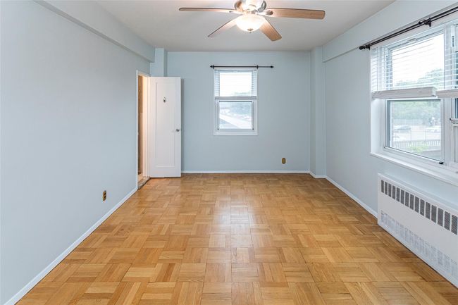 The primary bedroom is a corner room with en suite bath | Image 12