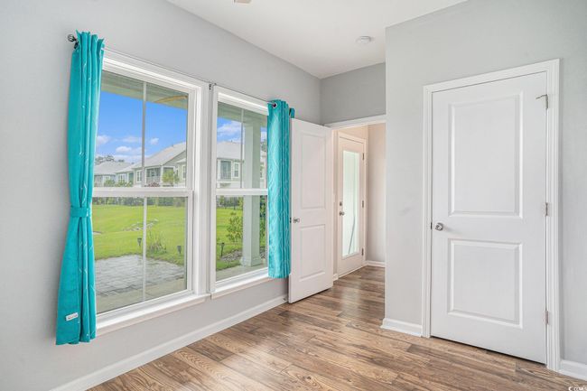 Empty room with wood finished floors and a smoke detector | Image 26