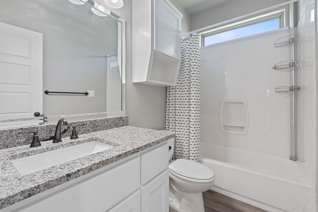 Full bathroom with vanity, shower / tub combo with curtain, and wood finished floors | Image 26