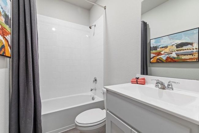 Full bathroom featuring large vanity, shower / bathtub combination - main floor | Image 15