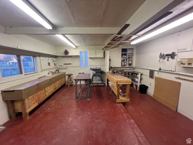Heated shop connected to the garage with lots of light, and areas for being organized | Image 19
