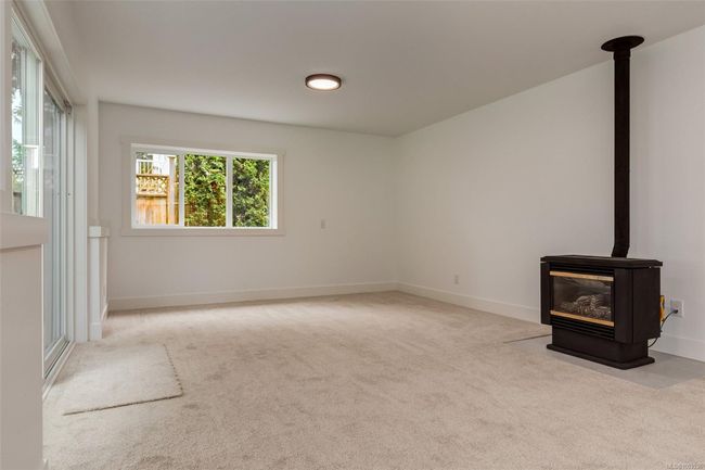 Rec room with fireplace and access to backyard | Image 69
