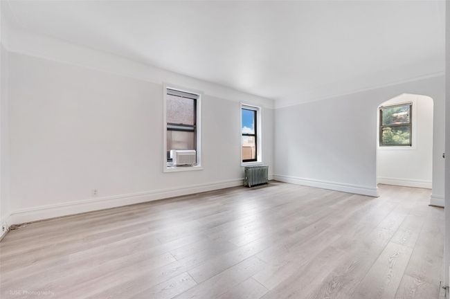 Spare room with baseboards, radiator heating unit, light wood finished floors, and cooling unit | Image 8