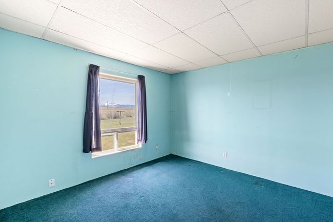 Carpeted spare room featuring a drop ceiling | Image 27