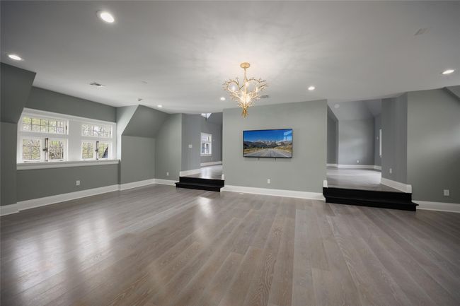 Additional living space featuring recessed lighting, wood finished floors, a chandelier, and baseboards | Image 16