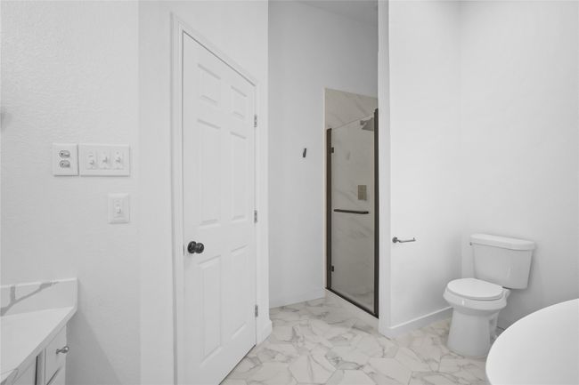 Full bathroom featuring marble finish flooring, a shower stall, and vanity | Image 14