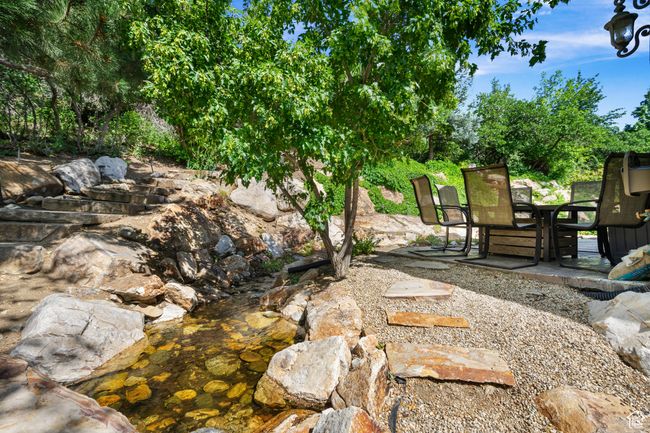 View of yard featuring outdoor dining area and a patio | Image 39