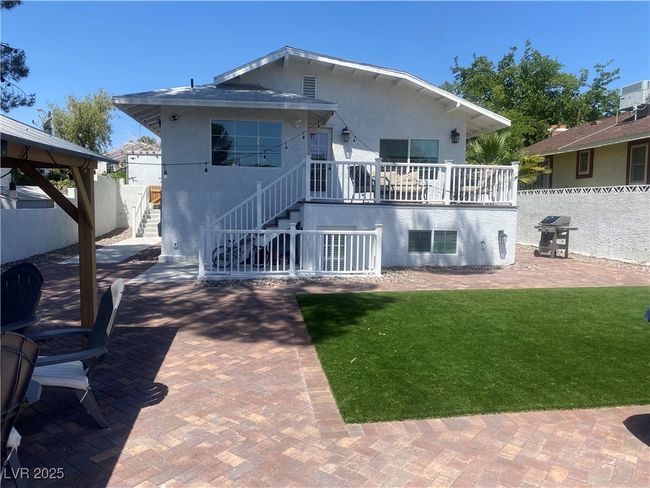 Rear view of house with stairs, a patio area, stucco siding, and a gazebo | Image 31