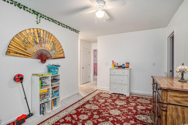 Bedroom featuring baseboards, ceiling fan, and light colored carpet | Image 20
