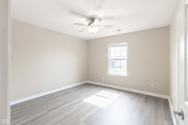 empty room featuring a ceiling fan and wood finished floors | Image 22