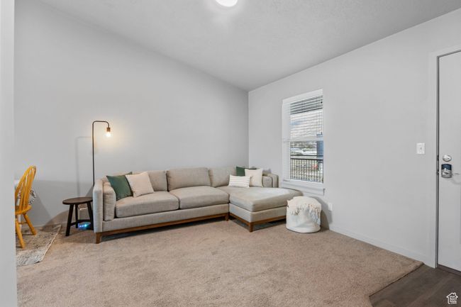 Carpeted living area with baseboards and vaulted ceiling | Image 10