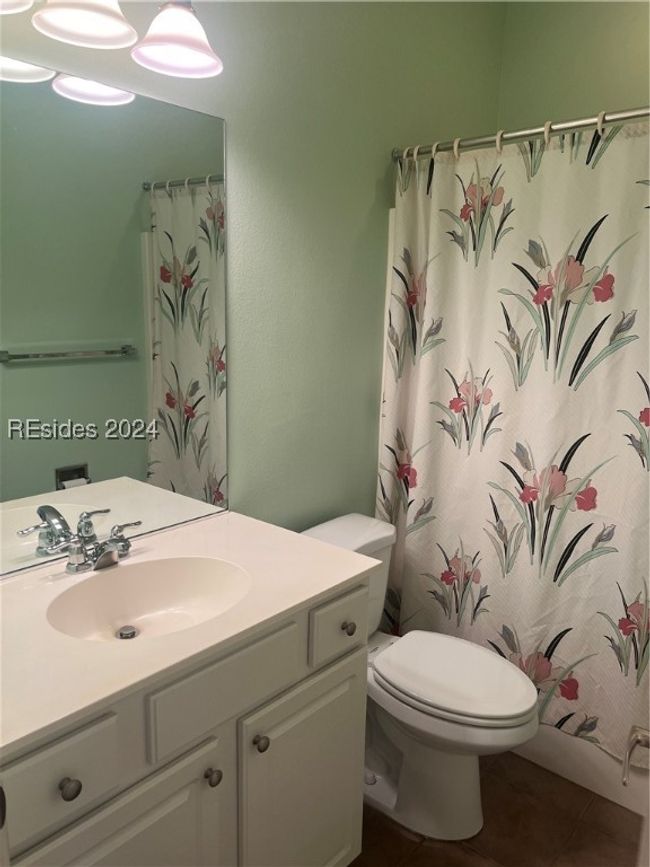 Bathroom featuring vanity, toilet, a shower with shower curtain, and tile patterned flooring | Image 24