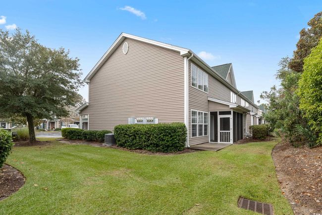 View of side of property with a yard, a sunroom, and central AC unit | Image 40