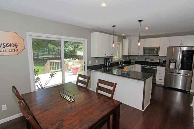 Dining room with sliding glass door leading out to the deck. | Image 6