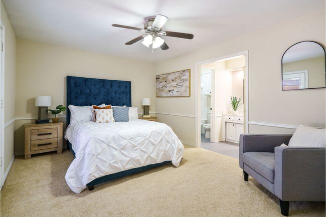 Guest bedroom with ensuite bath and a ceiling fan | Image 24