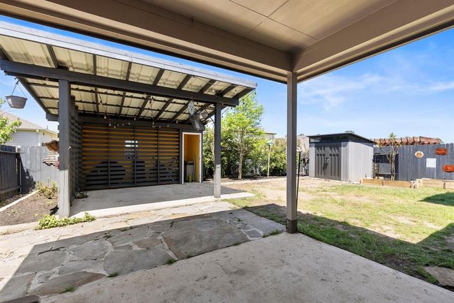 Enjoy this covered back patio extension with additional storage and an outdoor fan to cool off on a hot Texas day. | Image 40