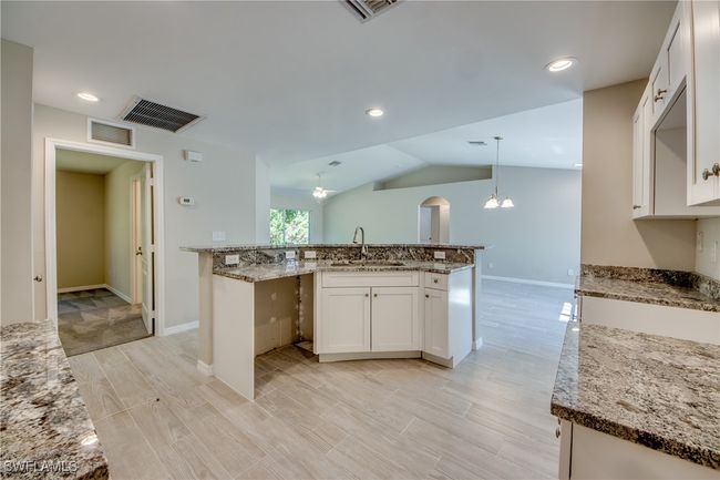 Kitchen with visible vents, a sink, and an inviting chandelier | Image 26