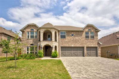 View of front of house featuring a front lawn and a garage | Image 1