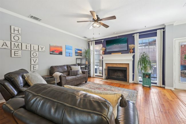 The cozy living area overlooks the backyard and patio. | Image 15