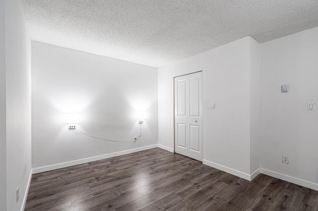 Spare room with a textured ceiling and wood finished floors | Image 15
