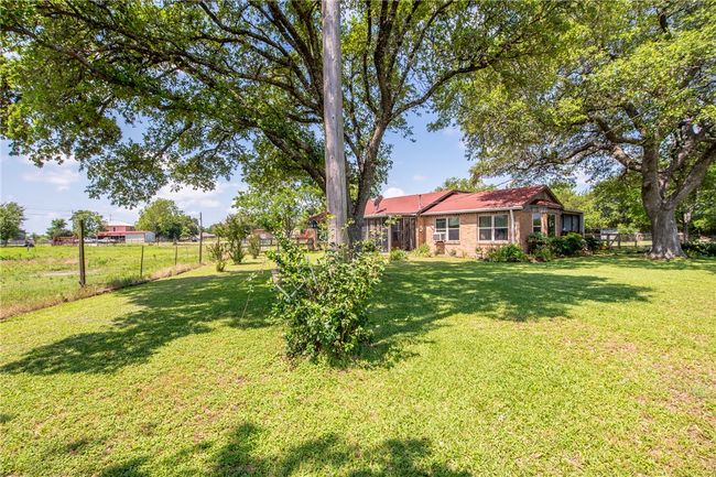 View of fenced backyard | Image 9