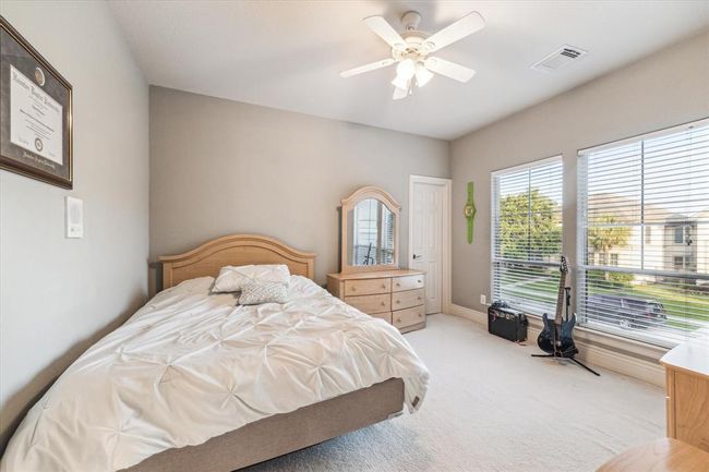 Bedroom #4 overlooks the front of the home & also features an en suite bathroom. | Image 30
