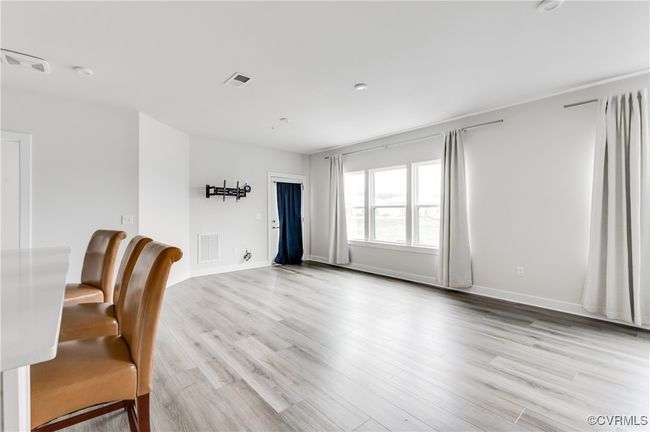 Unfurnished dining area featuring light wood finished floors and baseboards | Image 5