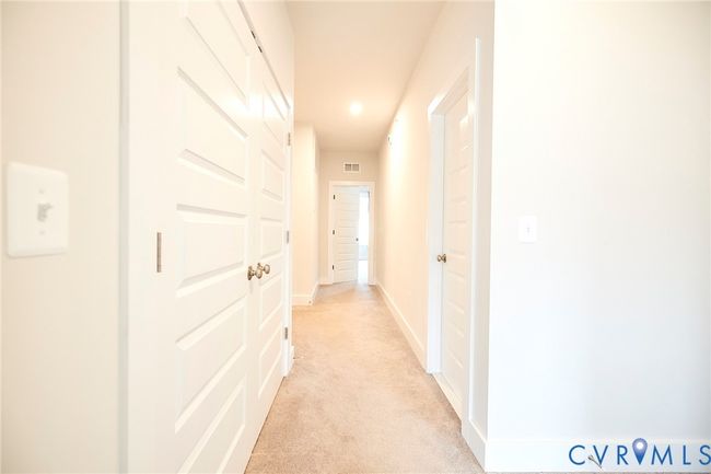 Hall with light carpet and recessed lighting | Image 18
