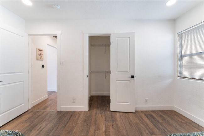 Unfurnished bedroom featuring baseboards, wood finished floors, and a spacious closet | Image 26