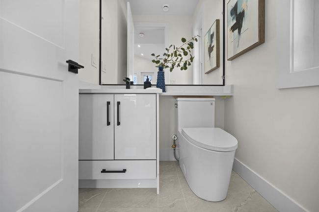 Bathroom featuring toilet and vanity | Image 29