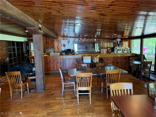 Dining space with wooden ceiling and wood finished floors | Image 35