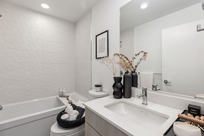Full bath featuring vanity, a bathtub, recessed lighting, and toilet | Image 9