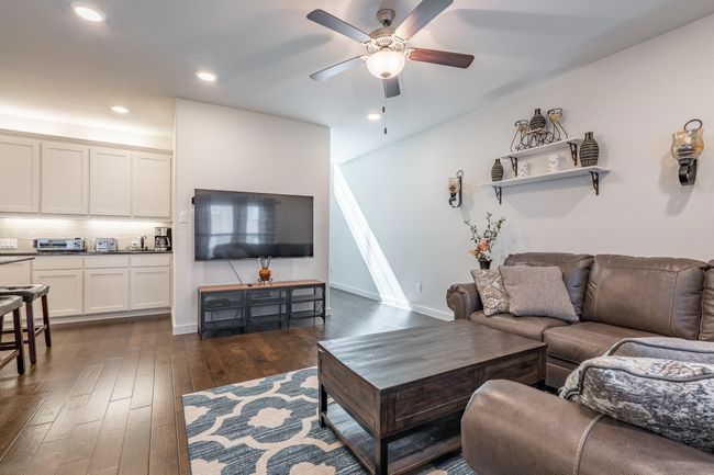 Living area featuring dark wood-type flooring, ceiling fan, and recessed lighting | Image 5