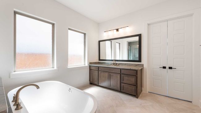 Bathroom with a soaking tub and vanity | Image 18