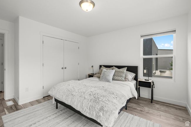 Bedroom with light wood-type flooring and a closet | Image 33