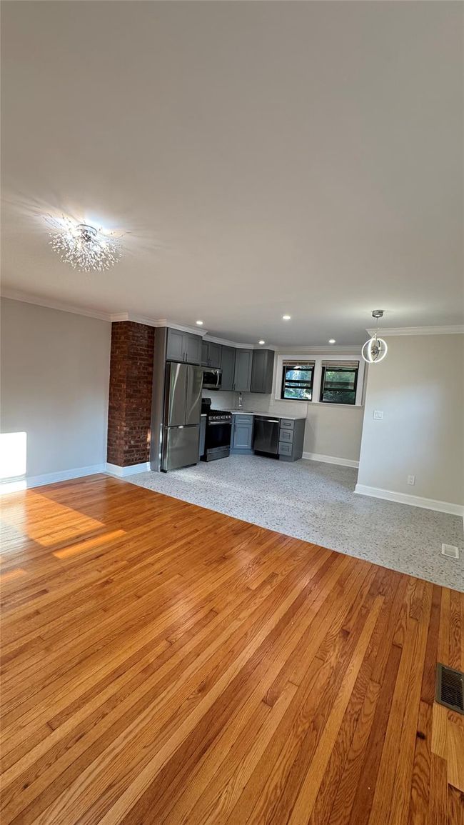 Unfurnished living room with crown molding, light wood-style flooring, and recessed lighting | Image 7