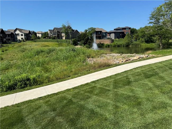 View of green lawn featuring a residential view and a water view | Image 73